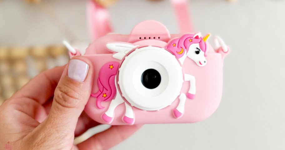 hand holding a pink unicorn kids digital camera