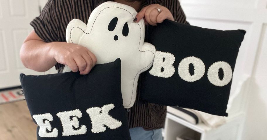 Woman holding Kohl's Halloween Throw Pills