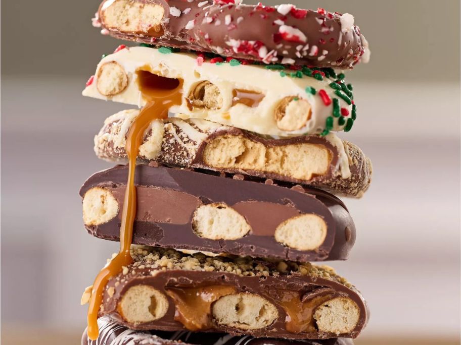 A stack of landie's Candies stuffed pretzel with the candies cut in half to show what's inside each one