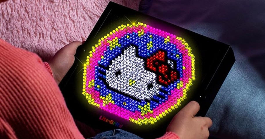 girl holding hello kitty lite brite design