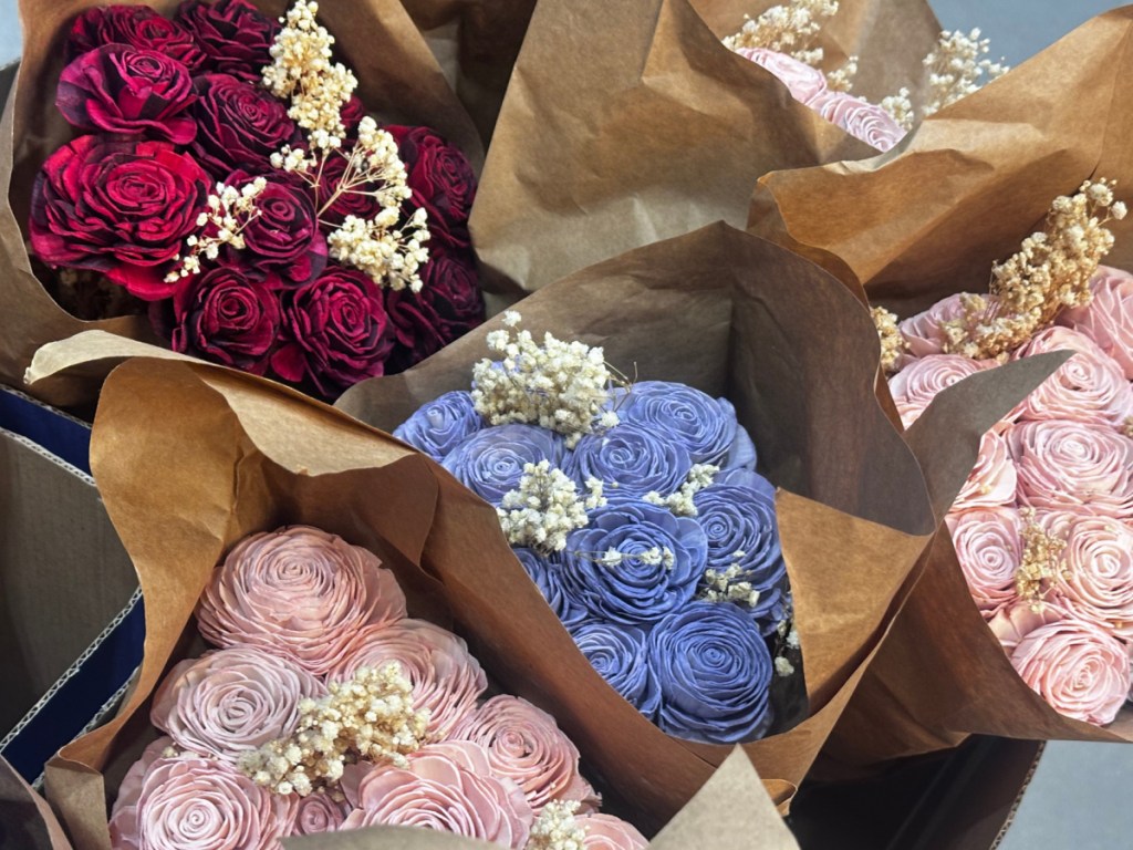 Red pink and purple paper flower bouquets inside Lowe's store