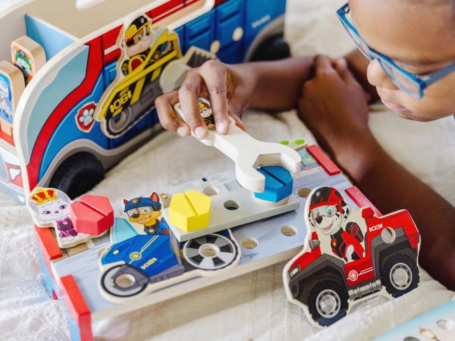 boy playing with Melissa & Doug PAW Patrol Match & Build Mission Cruiser