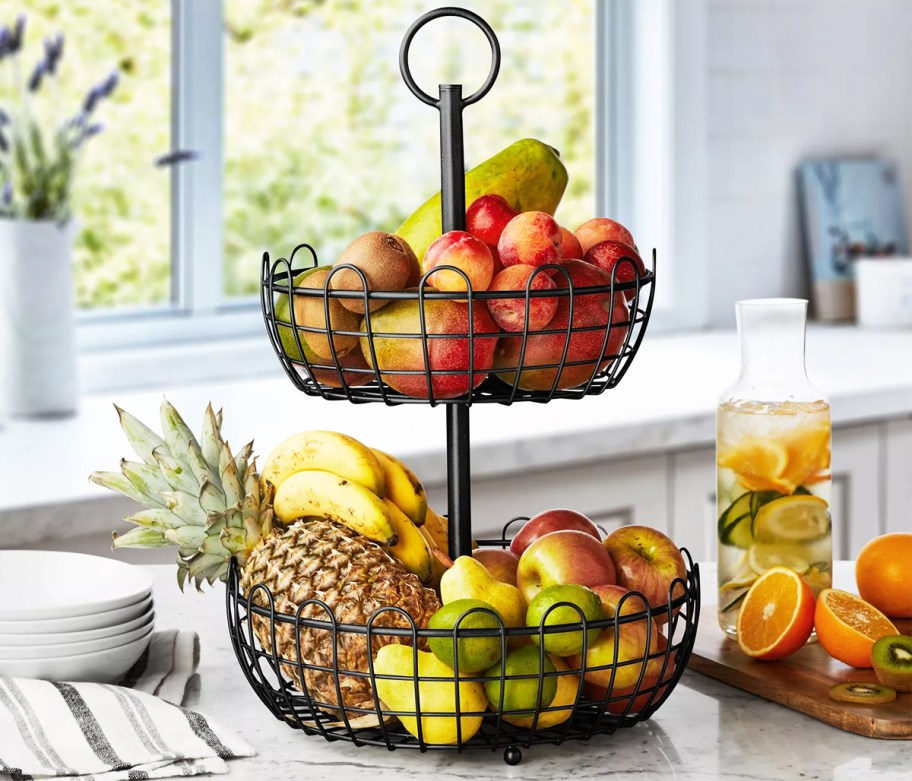 black 2-tiered fruit stand on counter