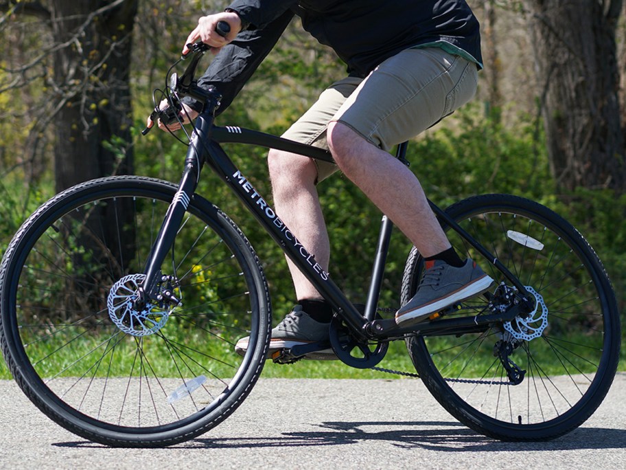 man riding a black bicycle