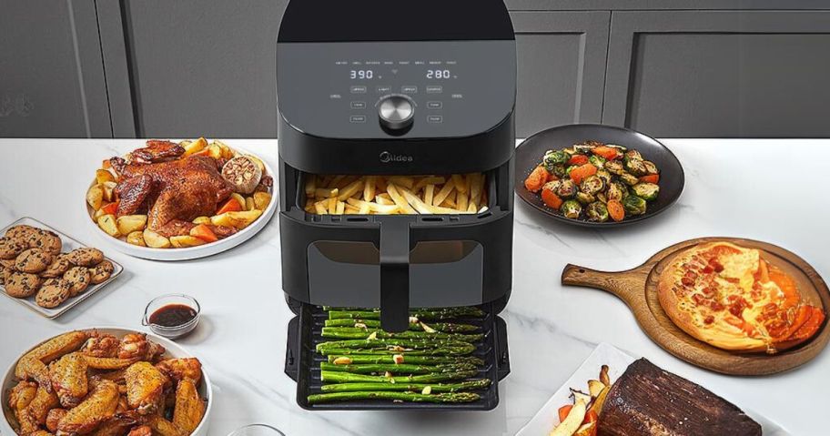 Midea Dual Basket Air Fryer Oven with food around it