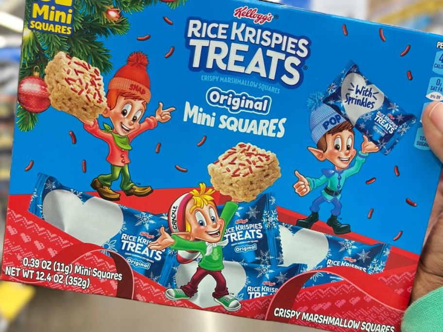 Hand holding a box of Mini Holiday Rice Krispies Treats