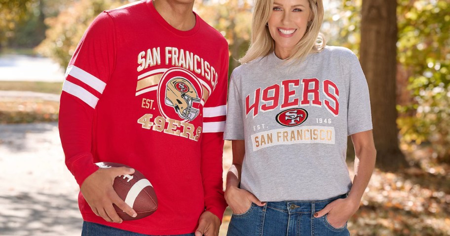 man and woman wearing 49ers t shirts and standing outside