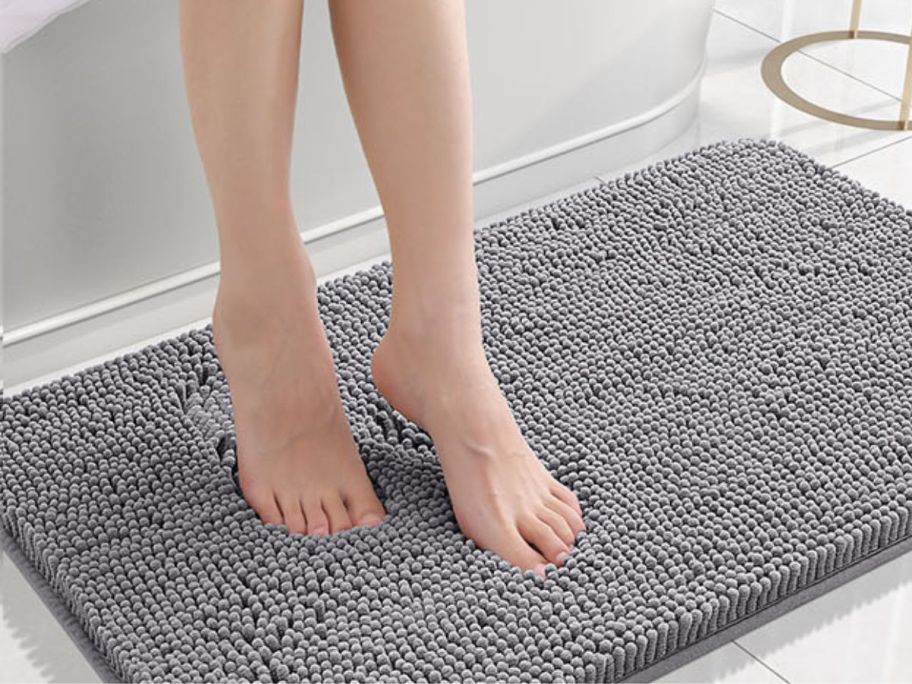 woman stepping out onto OLANLY 30"x20" Chenille Bath Mat in Grey from tub