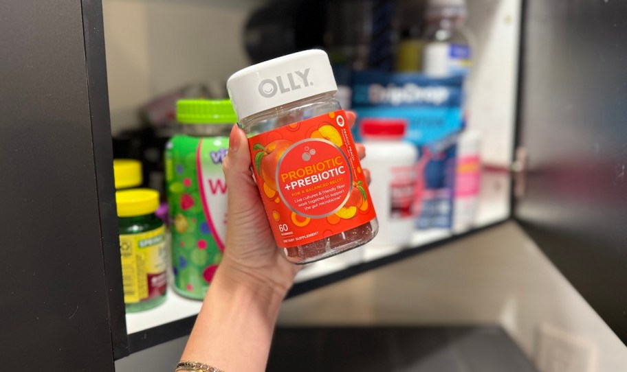 hand holding a container of OLLY Probiotic + Prebiotic Gummy