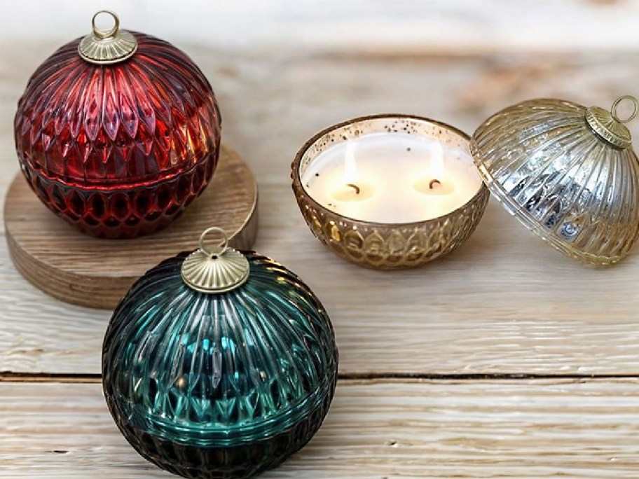 Ornament candles displayed opened and closed on a piece of wood