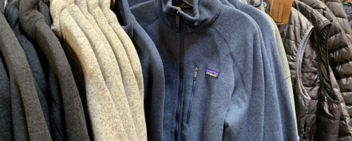 patagonia fleece jackets hanging on rack inside sstore