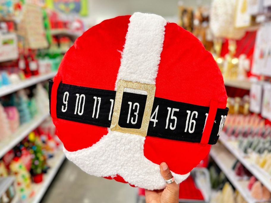 Santa Belt Countdown Calendar Round Christmas Novelty Throw Pillow in hand in store