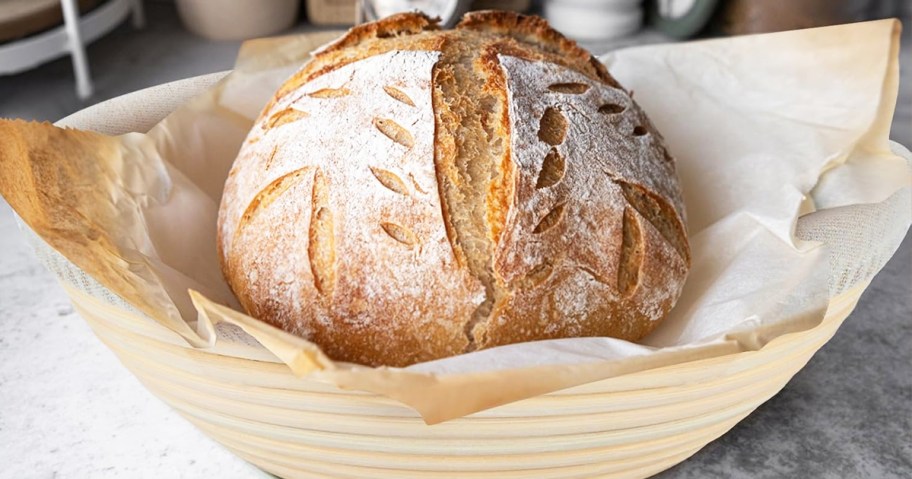 round loaf of sourdough bread inside a basket