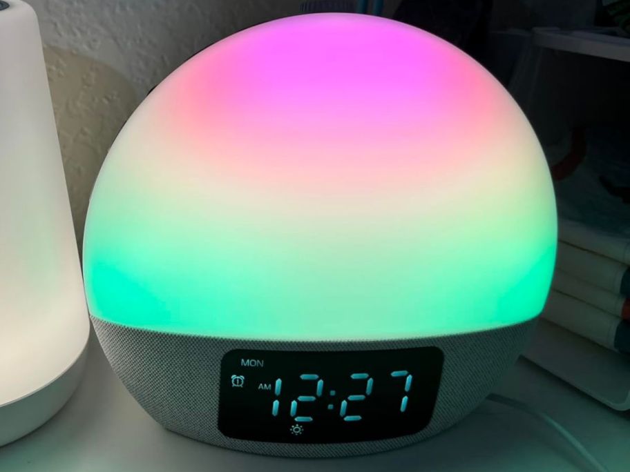 A sunrise alarm clock with a rainbow color glow