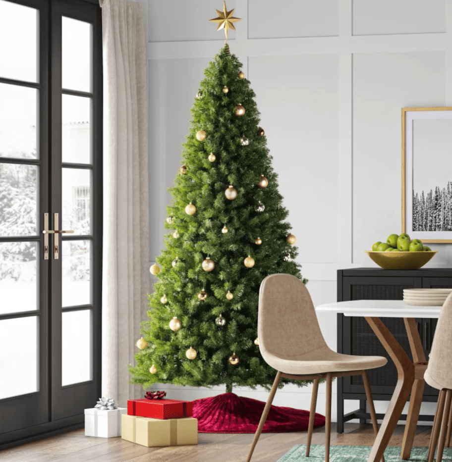 A full-size faux Christmas Tree from target set up in a living room