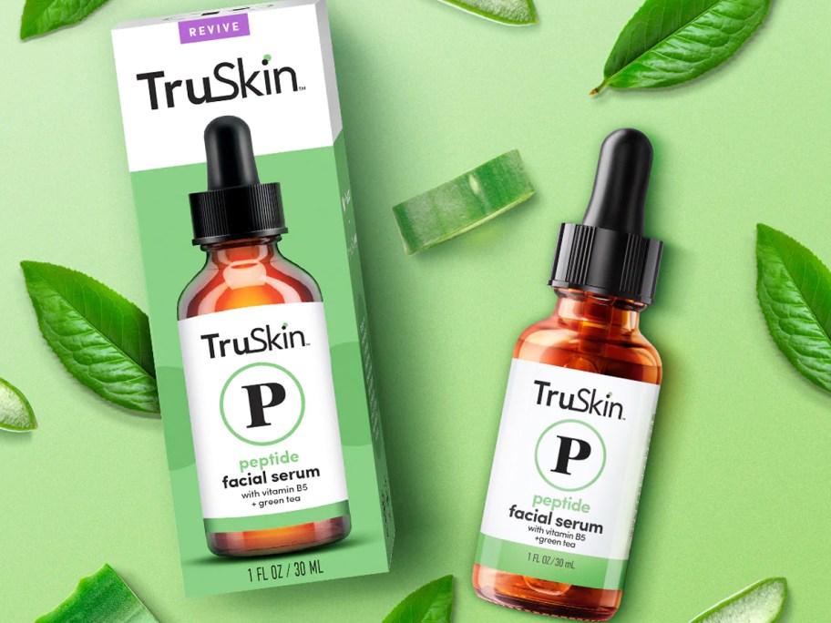 box and bottle of TruSkin Peptide Serum surrounded bt green leaves