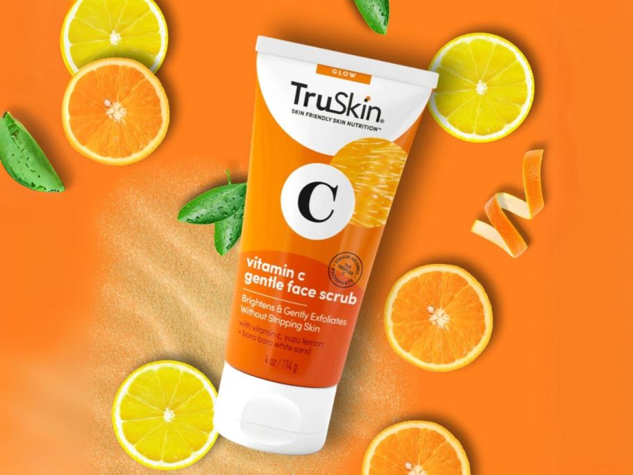 TruSkin Vitamin C Gentle Face Scrub 4oz against orange background with orange slices