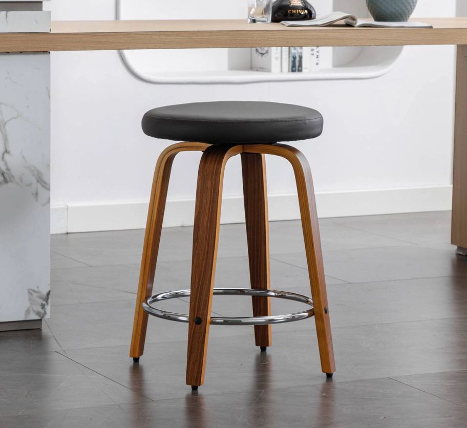 a round swivel counter height stool with a black cushion