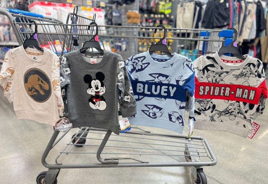 4 Kids character sweatshirts hanging from a walmart shopping cart