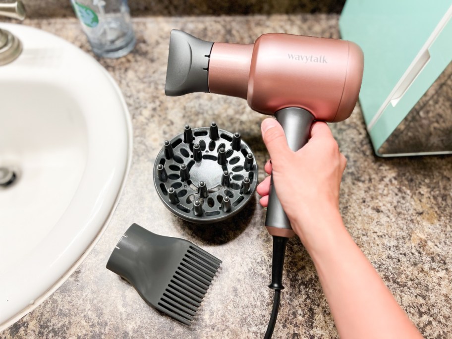 hand holding a Wavytalk hair dryer from amazon, a dyson hair dryer alternative