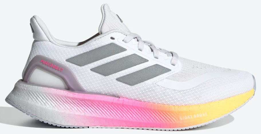 white and grey running shoe with pink and yellow sole