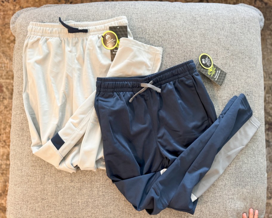grey and blue boys joggers on ottoman