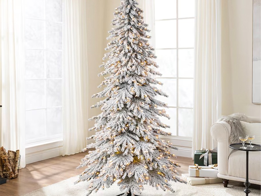 white artificial chistmas tree in living room with lights 