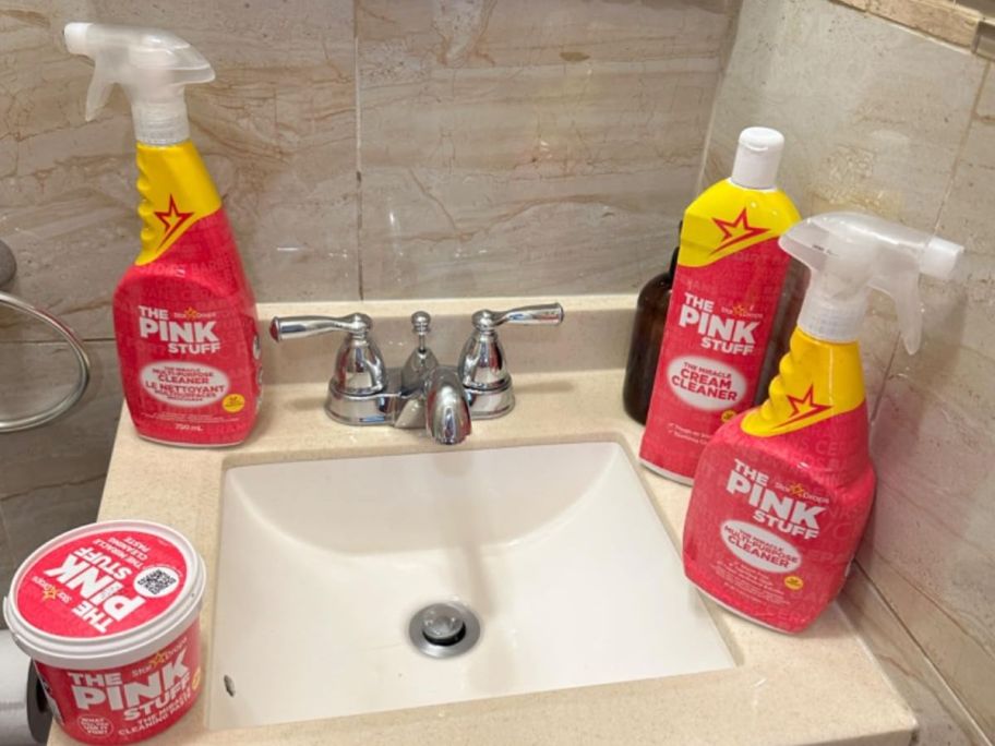 bathroom counter top with the pink stuff bundle on it