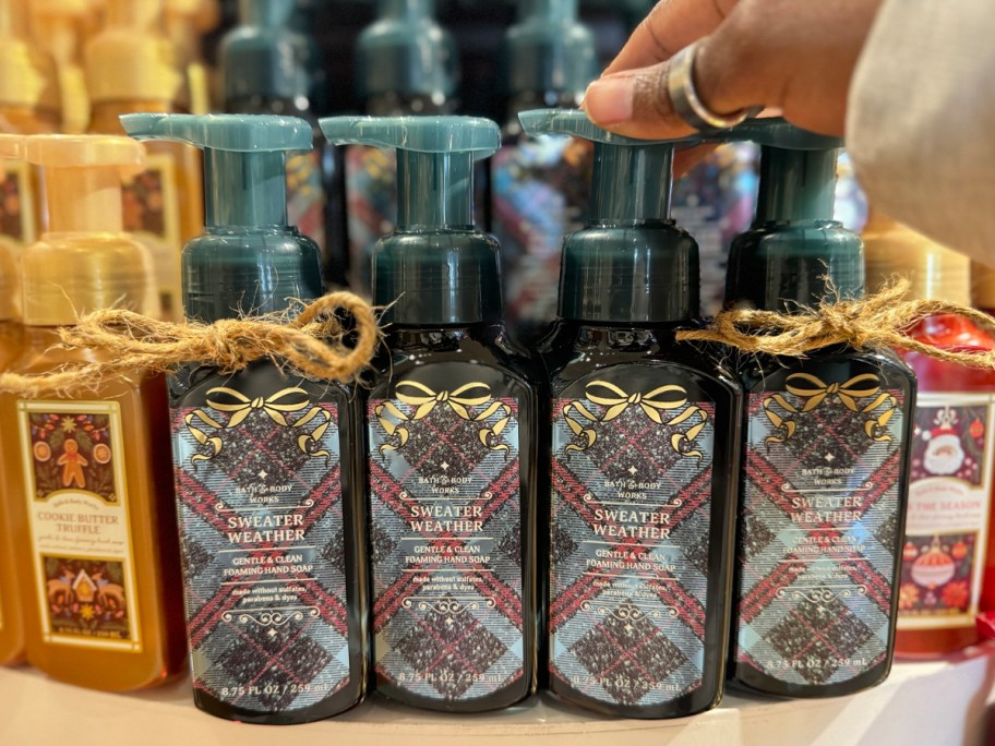 hand reaching for bbw sweater weather hand soaps 