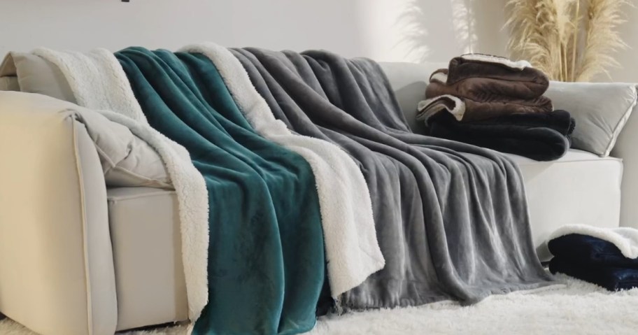 sherpa fleece throw blankets on a couch in green, cream, grey and other colors