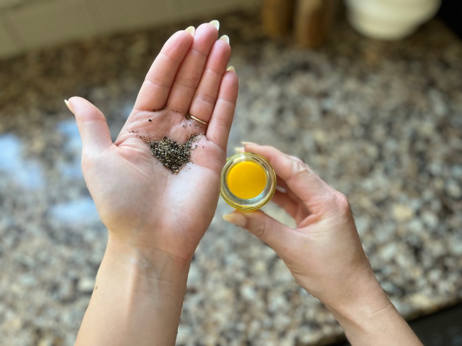 hand with small pile of cracked black pepper in palm 