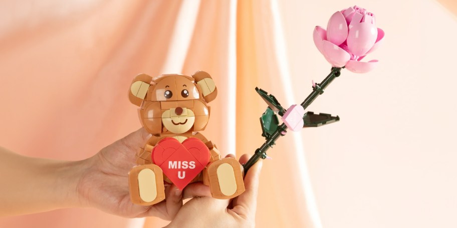 hand holding bear and rose brick toys