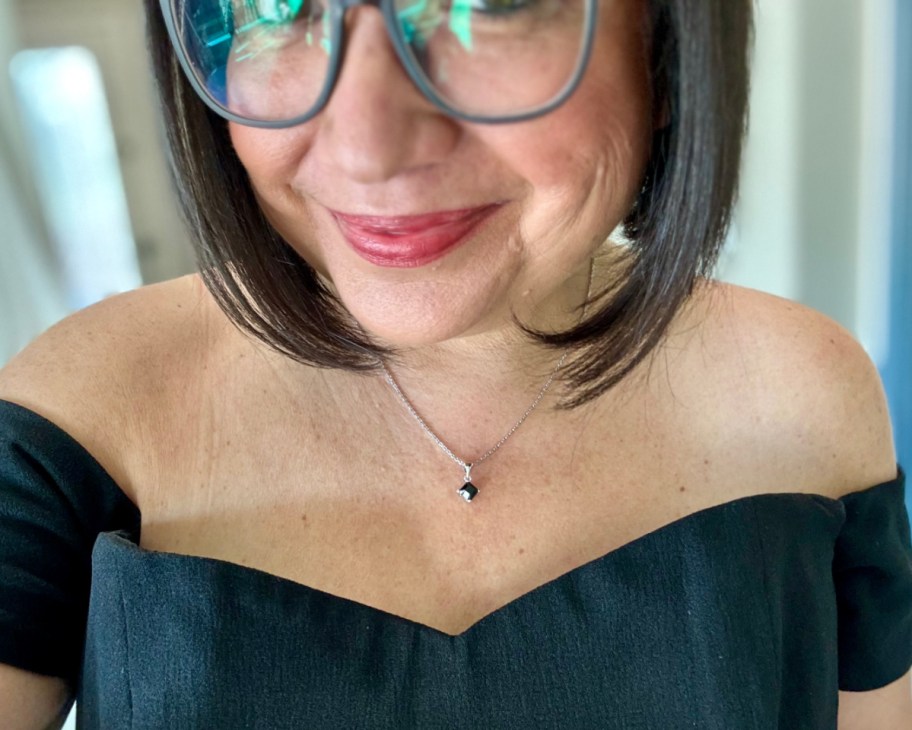 woman in black dress wearing black necklace