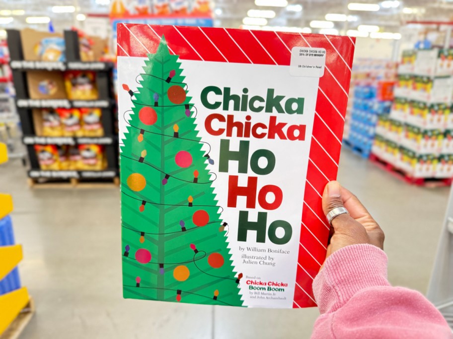 hand holding a chicka chicka ho ho ho book in store