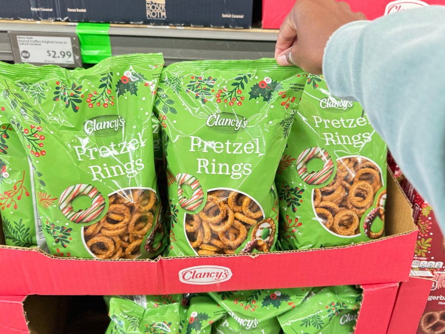 hand reaching for bag of pretzel rings 