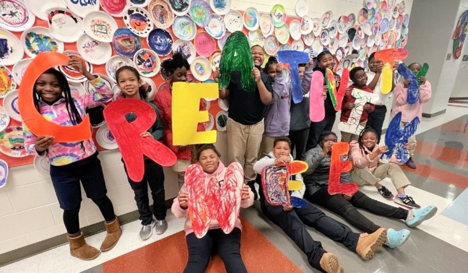 children holding up colorful letters