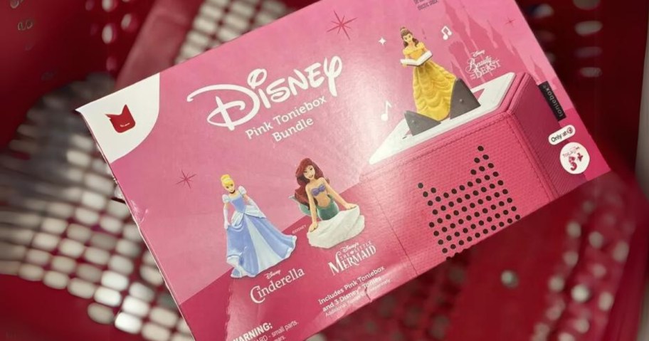 a pink box with a Toniebox audioplayer in pink and Disney princess figurines in a Target cart