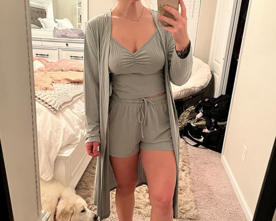 woman in 3 piece beige lounge set taking selfie