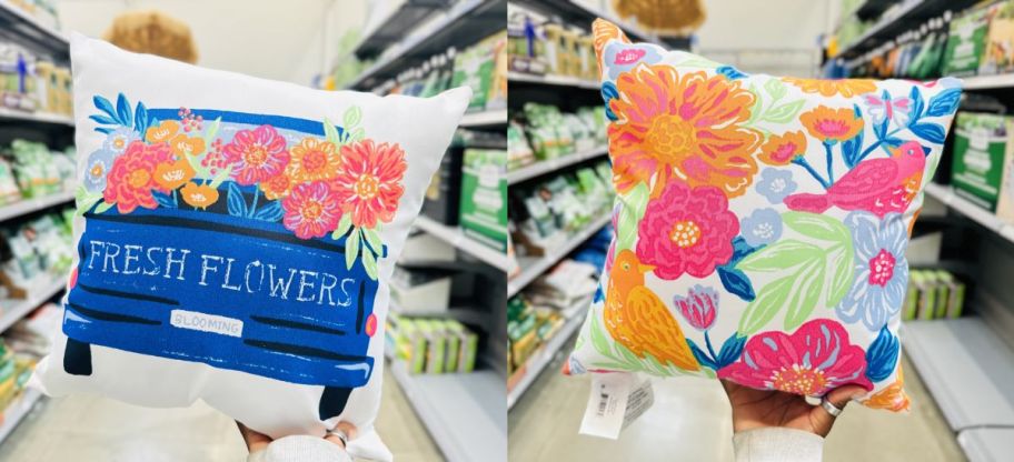 a womans hand holding up a flower truck throw pillow on a store aisle