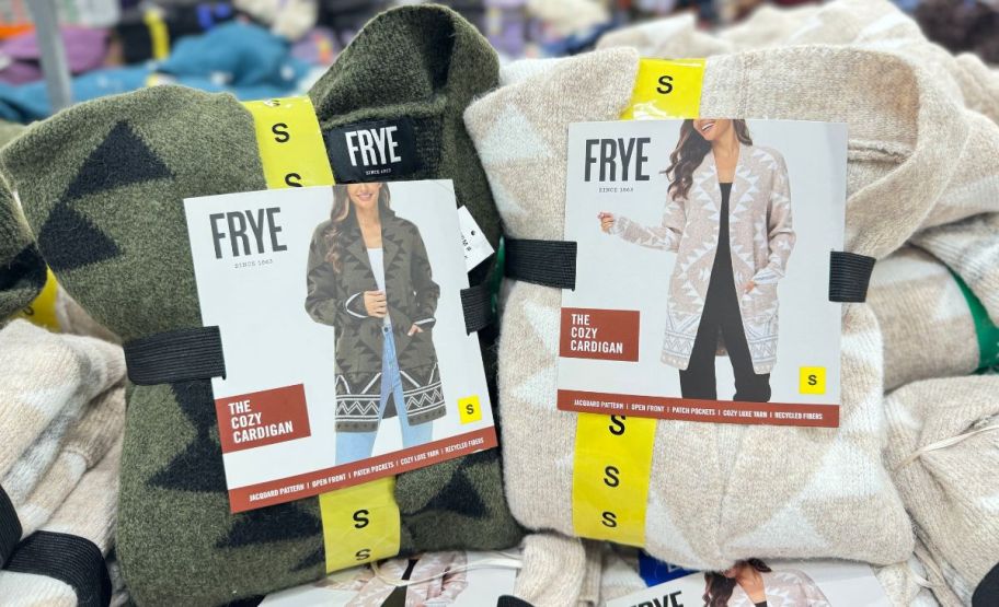 two FRYE women's cozy cardigans on a display table in a costco club