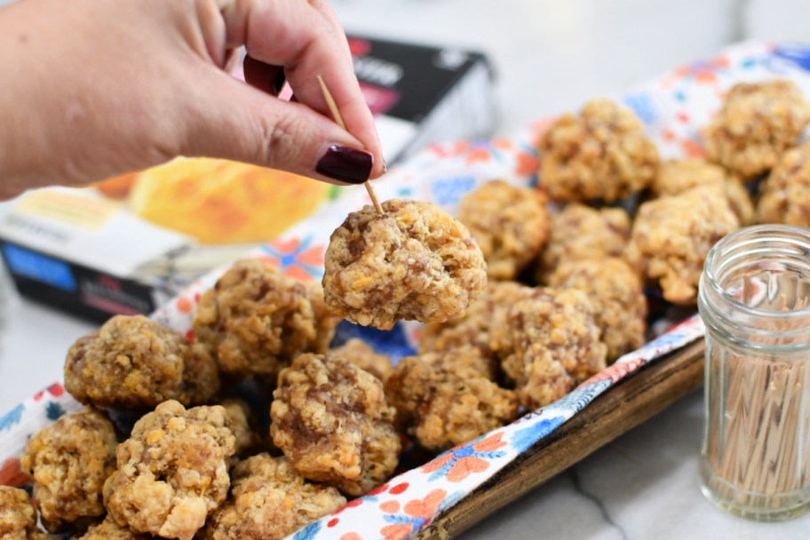 holding a sausage ball on a toothpick 