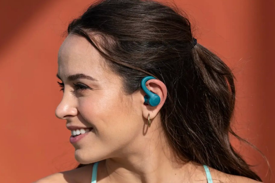 woman wearing teal hook earbuds 