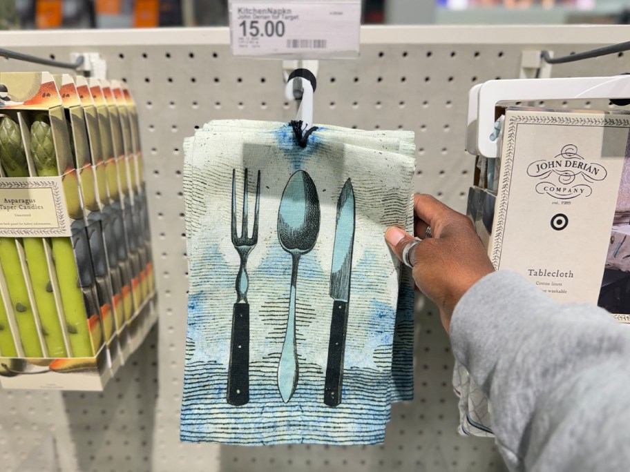 hand reaching for cutlery napkin set on display 