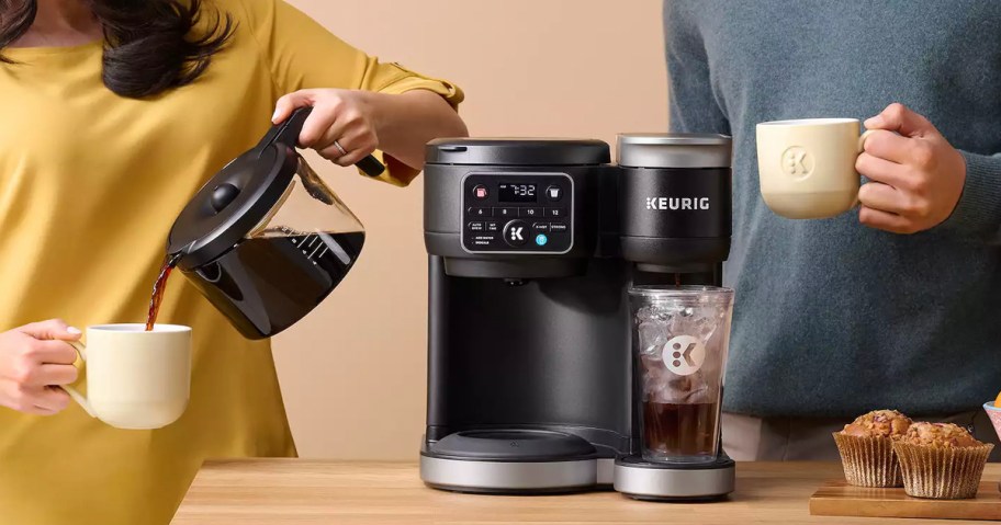 person pouring coffee into mug from keurig coffee maker 