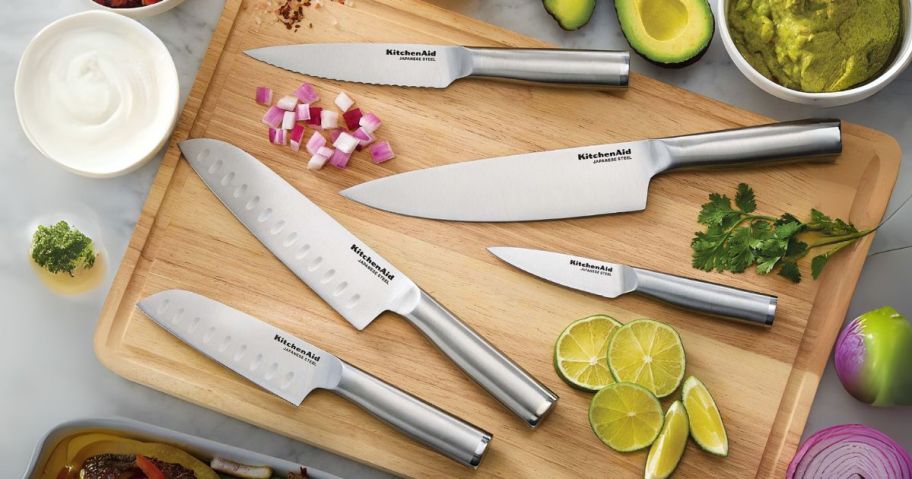 KitchenAid Gourmet 5-Piece Forged Stainless Steel Knife Set on cutting board with food around them