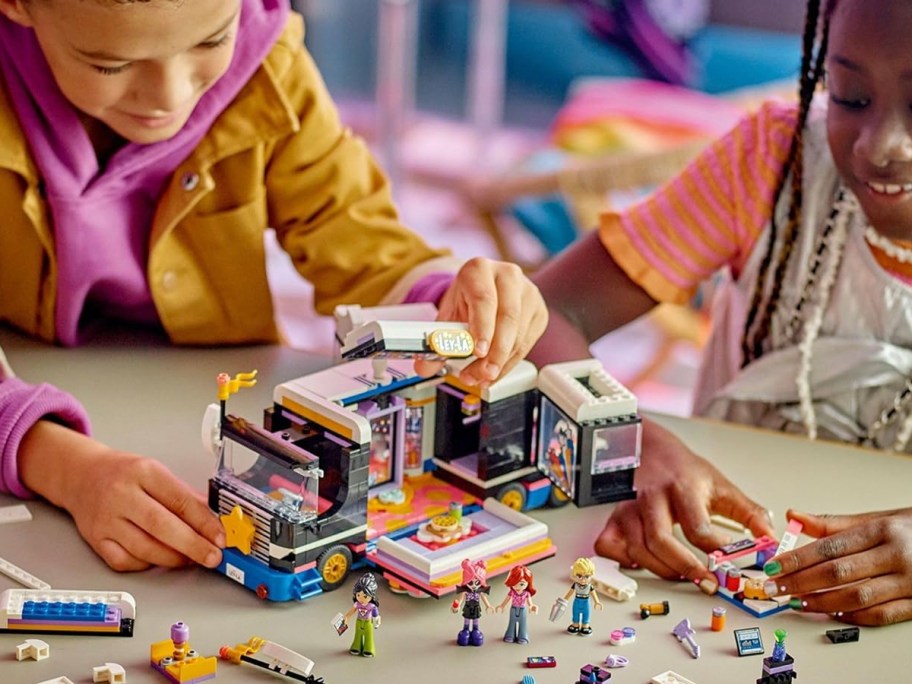 two kids playing with lego band set 