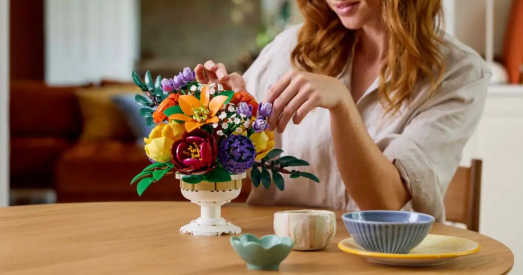 woman creating lego floral bouquet