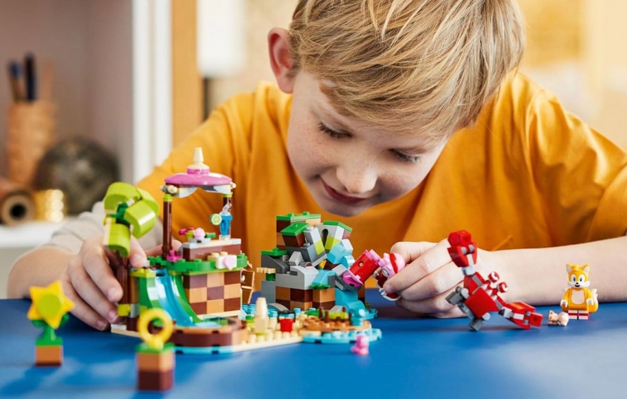 boy playing with lego sonic set