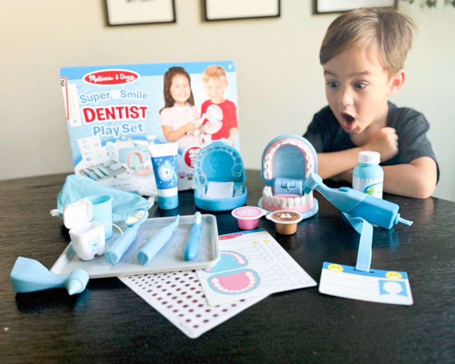 boy looking at dentist playset 