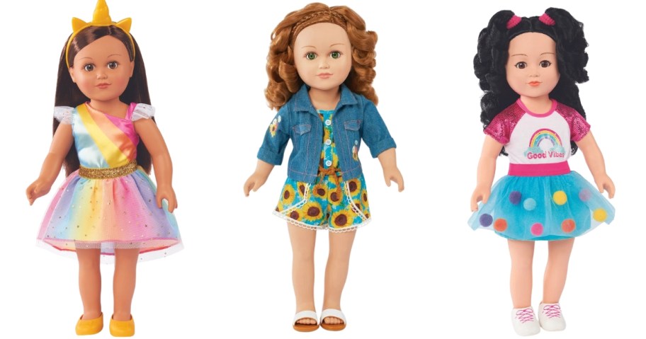 3 dolls, one with brown hair in a colorful dress wearing a unicorn tiara, one with red hair wearing a dress and jean jacket and one with brown hair wearing a tshirt and blue polka dot tutu